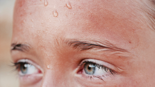 Close-up of a woman with sweat on her forehead