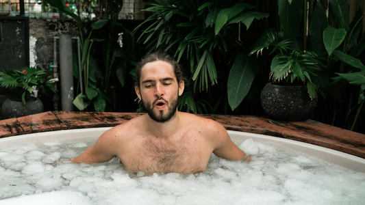 Man plunging into an ice-cold bath outdoors